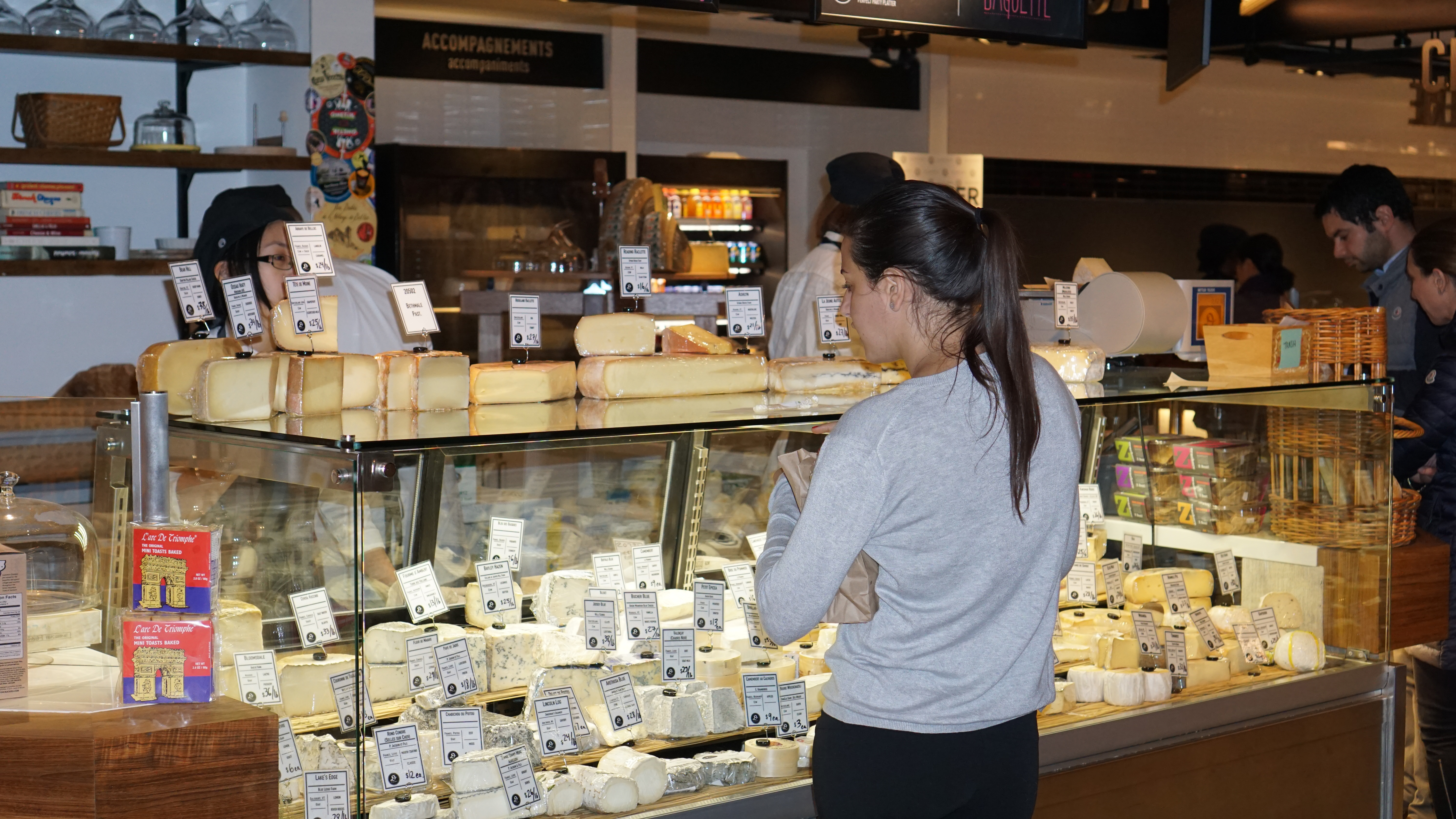 Le District Fromagerie lady at counter shopping